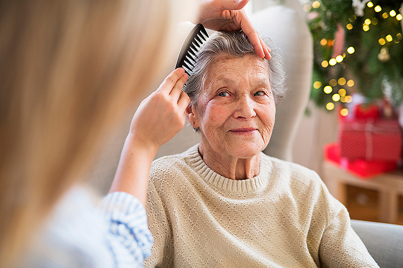 Lady with dementia having hair brushed